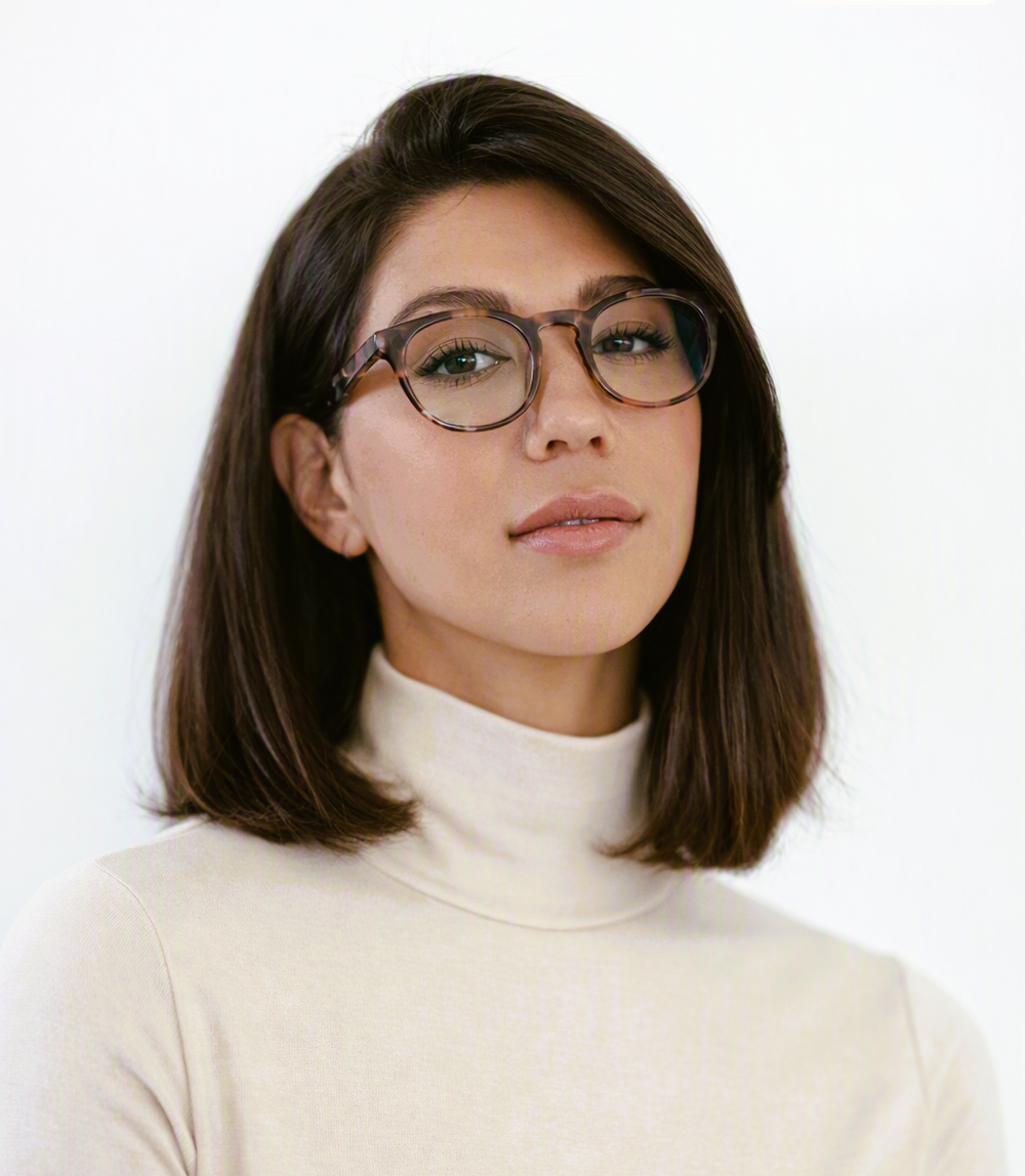 minimalistic photo of young woman wearing round tortoiseshell blue light computer reading glasses | Renee's Readers