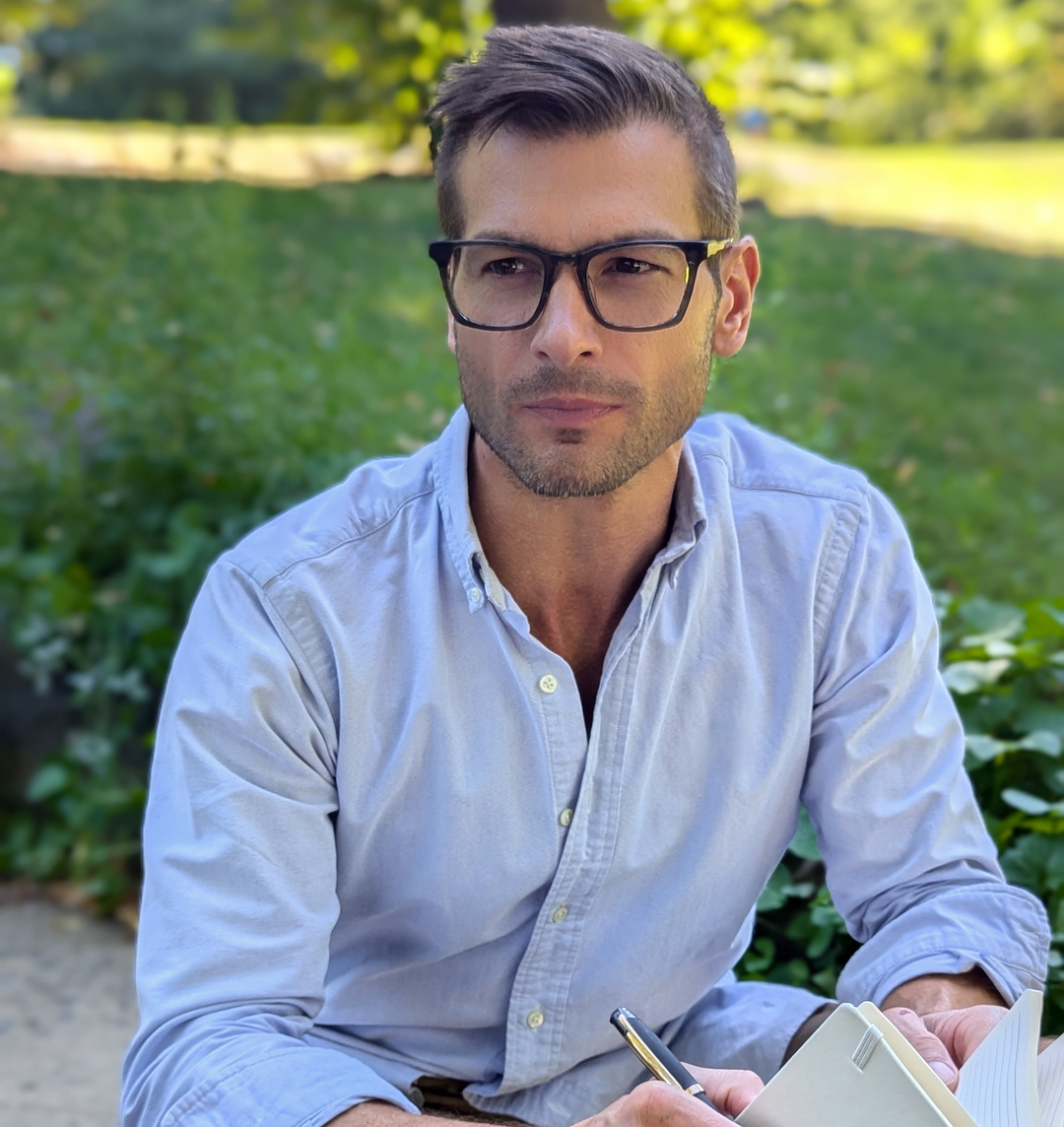 man wearing reading glasses on a beautiful day