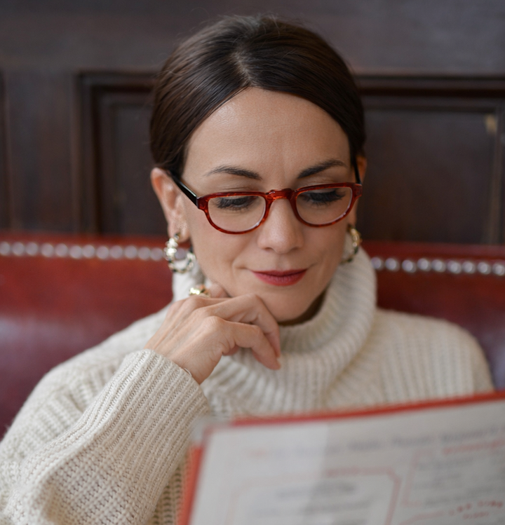 wearing red half frame glasses reading a menu  | Renee&